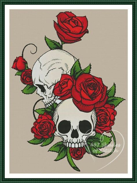 Two Skulls With Roses On Their Heads Are Shown In This Cross Stitch