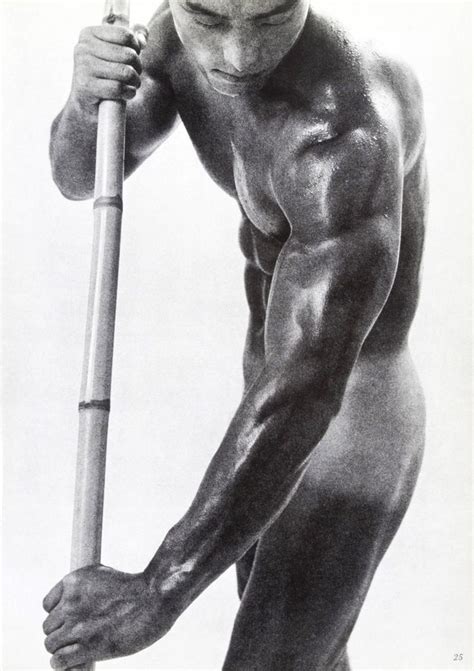 A Naked Man Holding A Baseball Bat And Posing For A Photo In Black And