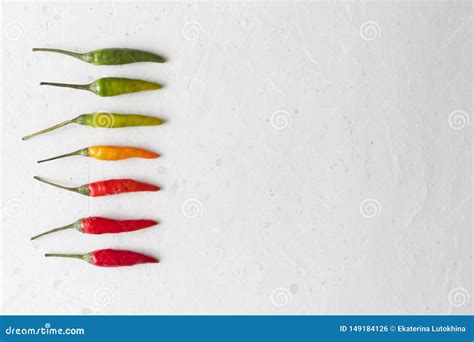 Red Hot Chili Peppers On Background Or White Table A Lot Of Red Chilli Peppers Green Yellow