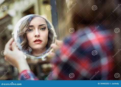 Young Woman Looking At Herself In A Little Mirror Stock Photo Image