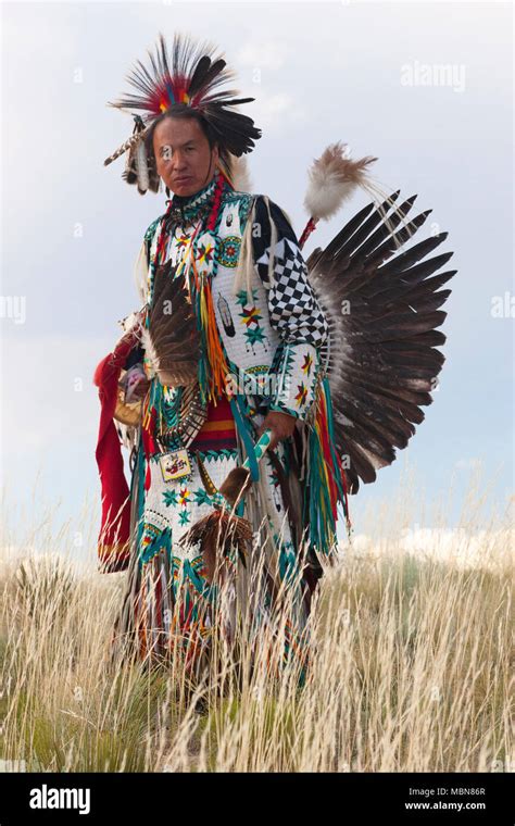 Native American Man Wearing Traditional Cheyenne Dress In The Plains