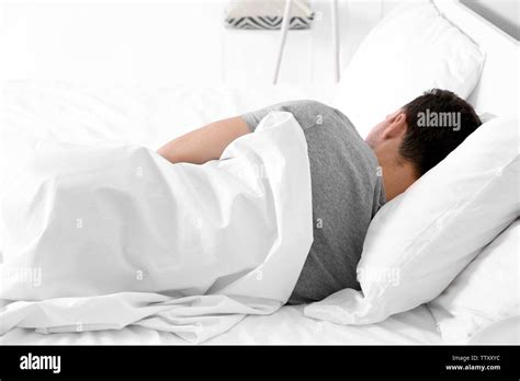 Tired Young Man Sleeping In Bed Stock Photo Alamy