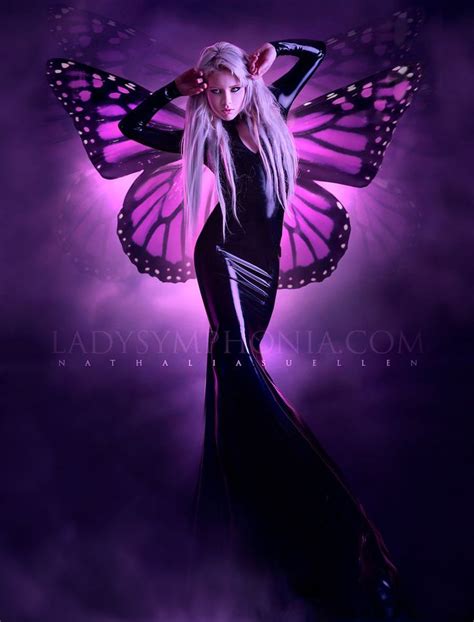 A Woman In A Black Dress With Butterfly Wings On Her Head And Purple