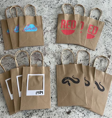 Brown Paper Bags With Red And Black Images On Them Sitting On A Counter Top Next To Each Other