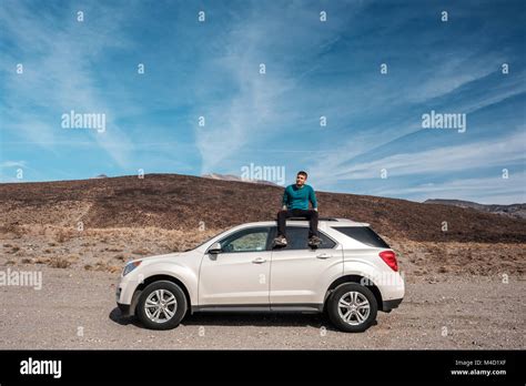 Man Sitting On Car Roof At Highway Shoulder Stock Photo Alamy