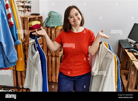 Brunette Woman With Down Syndrome Holding Hangers With Different