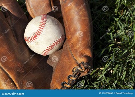 Antique Leather Baseball Mitt And Ball Closeup On Grass Field Stock