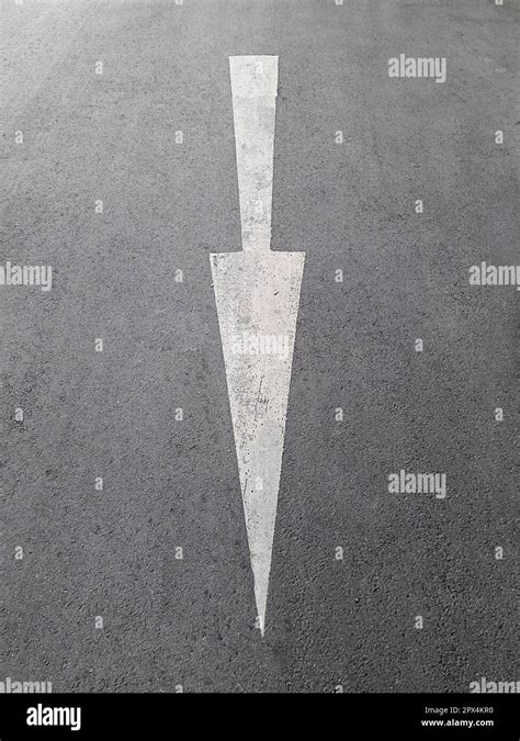 Road, with white arrow sign Stock Photo - Alamy