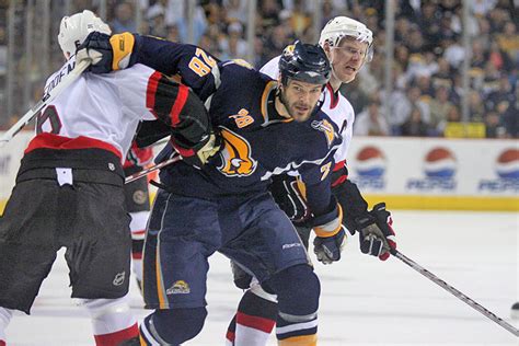 Buffalo Sabres forward Paul Gaustad fights his way through the Ottawa ...