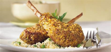 Two Meatballs Are Sitting On Top Of Rice And Garnished With Green Leaves