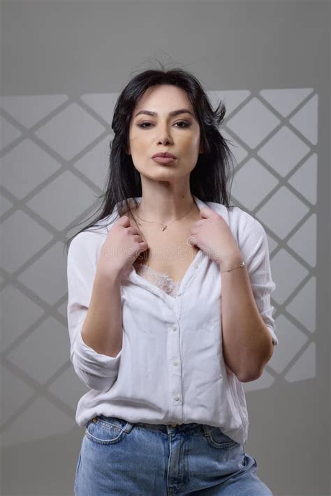 A Beautiful Brunette Woman In A Casual Outfit In The Studio Stock Image