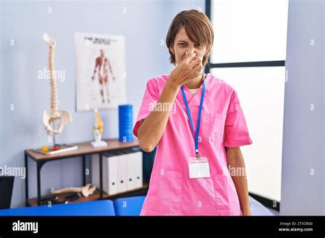 Brunette Woman Working At Rehabilitation Clinic Smelling Something