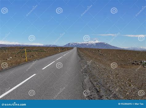 Long Asphalt Road F35 In The Central Iceland Between Brown Fields And