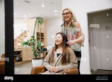 Hairdresser Talking To Female Customer Sitting On Chair Stock Photo Alamy