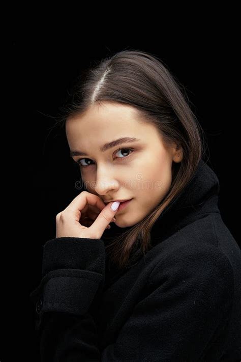 Dramatic Portrait Of A Beautiful Lonely Girl Isolated On A Dark