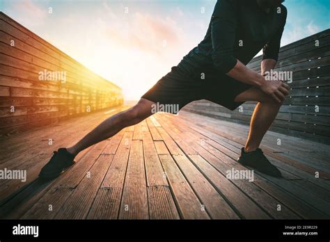 Fitness Man Stretching Legs Before Workout Outdoors Warming Up Before