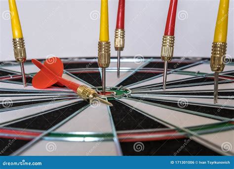 Red And Yellow Dart Arrows Hitting In The Target Center Of Dartboard