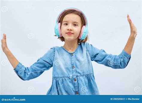 Girl Teenager In Casual Denim Dress Listening To Music In Headphones