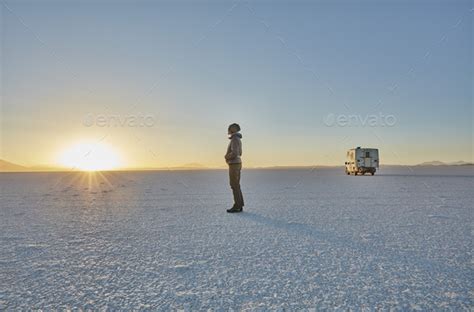 Bolivia Salar De Uyuni Woman Standing At Camper On Salt Lake At