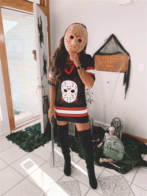 a woman wearing a mask standing in front of a door