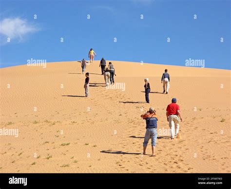 Tourists Climbing A Shifting Sand Dune Gobi Desert Mongolia Stock