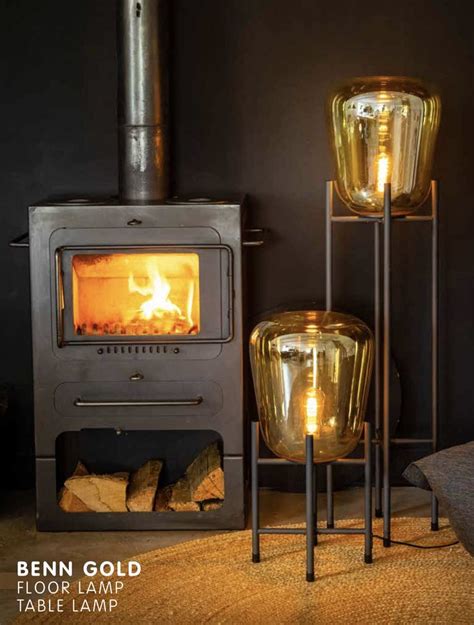 Two Metal Lamps Sitting Next To Each Other In Front Of A Fire Place