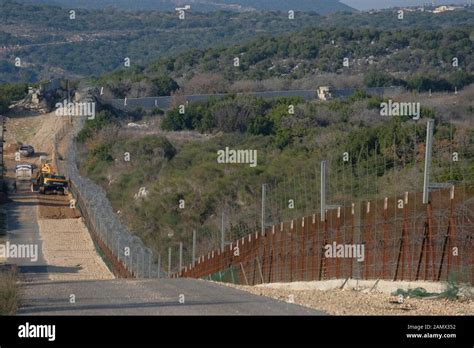 Engineering Vehicles Level Land Along The Border With Lebanon Near The