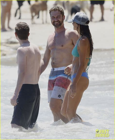 Gerard Butler Goes Shirtless While Hitting The Beach With Bikini Clad Girlfriend Morgan Brown