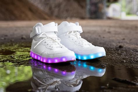 Premium Photo | White modern sneakers with colorful led lights in soles