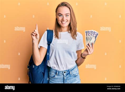 Beautiful Blonde Woman Wearing Student Backpack And Holding Japan