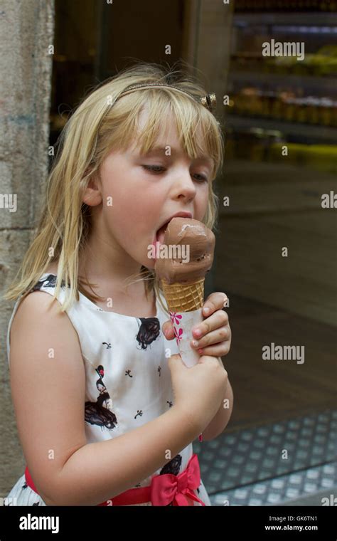 Adorable Young Girl Eating Chocolate Ice Cream Cone Stock Photo