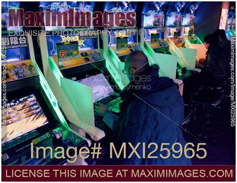 photo  people playing border break arcade slot machines stock image