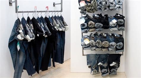 There Are Many Pairs Of Jeans Hanging On The Rack