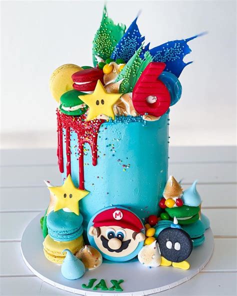 There Is A Cake Decorated With Mario And Other Items