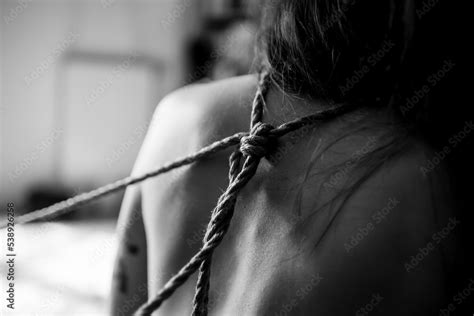 Стокове фото A young slim naked hot woman with decorative knots of natural ropes Ancient