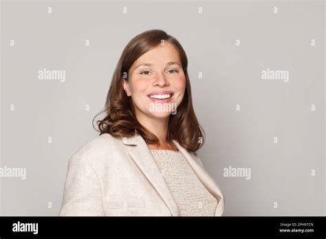 Indoor Portrait Of Beautiful Brunette Woman With Curly Hairstyle Smiling Cheerfully Showing Her