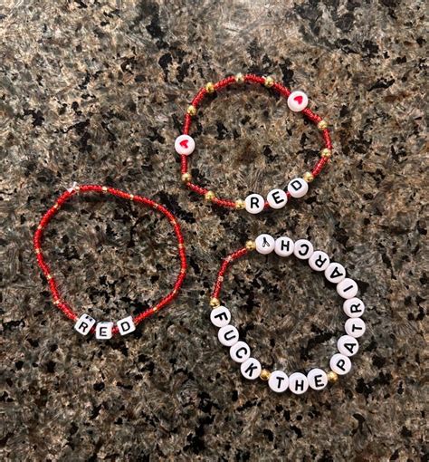 Two Beaded Bracelets Sitting On Top Of A Granite Surface