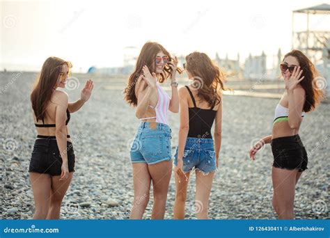 Women Strolling Along Coastline Female Friends Walking Together On