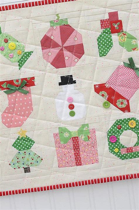 A Quilted Wall Hanging With Christmas Decorations On It