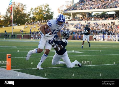 BYU wide receiver Puka Nacua, top, scores a touchdown against Georgia ...