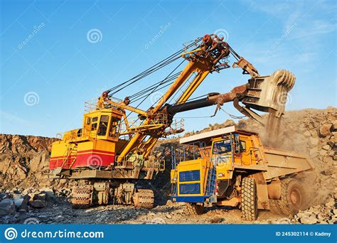 Mining Excavator Loading Granite Or Ore Into Dump Truck Stock Photo