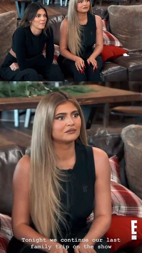 Two Women Sitting On Top Of A Couch Next To Each Other In Front Of A Tv