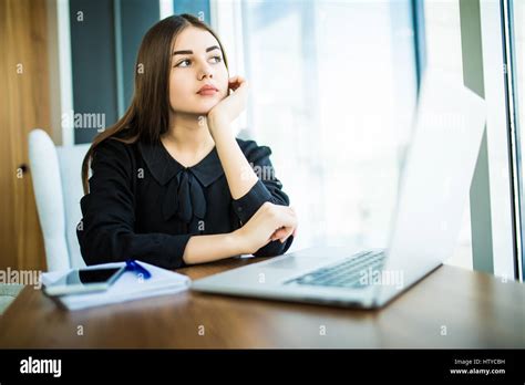 Beautiful Brunette Using Notebook In Cafe Near Window Stock Photo Alamy