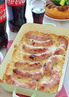 There Is A Pan With Sausages In It On The Table Next To Coke Bottles