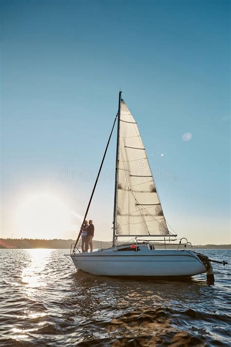 Romantic Senior Couple Enjoying Amazing Sunset While Standing On The