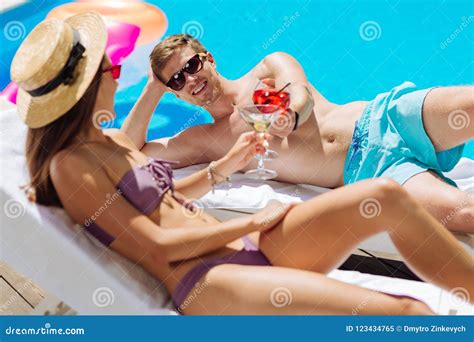 Dark Haired Woman Wearing Stylish Straw Hat Sunbathing With Man Stock