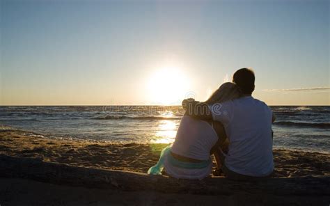 Couple Sitting Near The Sea On Sunset Stock Image Image Of Hold