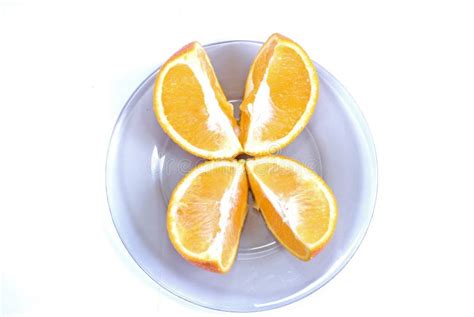 Orange Slices Cut Into 4 Parts Orange Lying On A Plate On A White