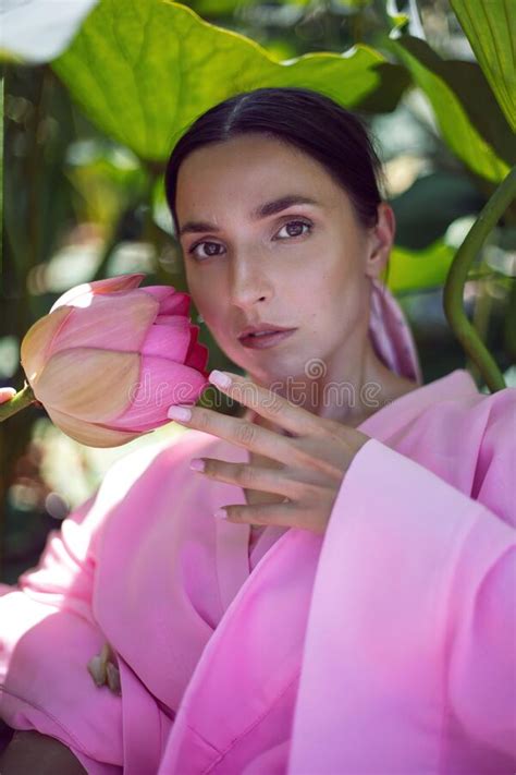Portrait Beautiful Brunette Woman In A Pink Dress Is Sitting On A Boat