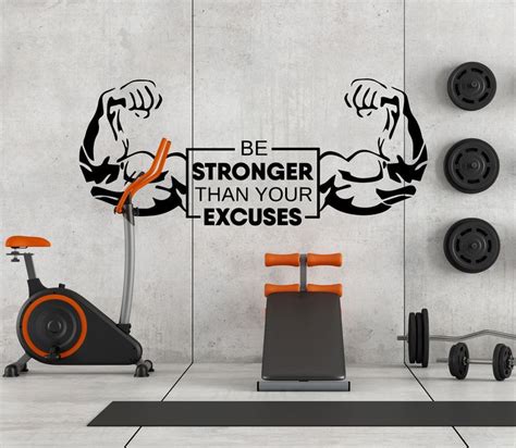 An Exercise Room With A Wall Decal That Says Be Stronger Than Your